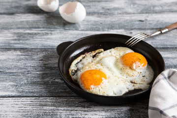 Fried egg. Close up view of the fried egg on a frying pan