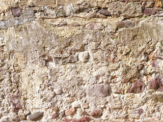 Background image as a wall of old stonework under a layer of plaster