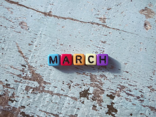 MARCH written on colored blocks.