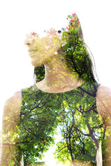 Double exposure close up of a young natural beauty with closed eyes combined with a healthy tree...