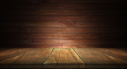 Old wood table on blurred wall background
