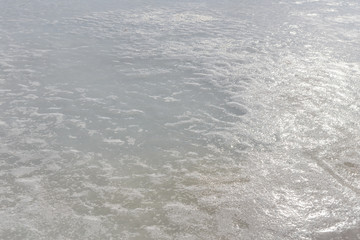 Ice texture on frozen lake in backlight