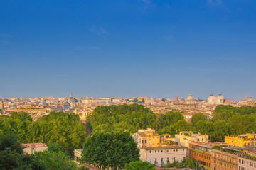 Fototapeta na wymiar Beautiful view of Rome, Italy. Sunny summer evening. Aerial panoramic cityscape of Rome. Rome skyline with the dome of Saint Agnese Church, the Campidoglio and the Altare della Patria monument.