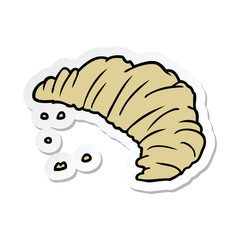 sticker of a cartoon croissant