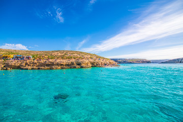 Comino, Malta - November, 2018: Tourists crowd at Blue Lagoon to enjoy the clear turquoise water on...