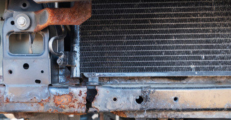 rusty arch of an old car. Rotten metal on the car. A hole from rust on the fender of the car