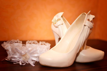 Wedding background of shoes and garter of the bride