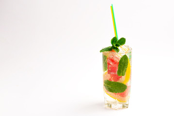 Summer detox drink with fresh fruits in glass jar.