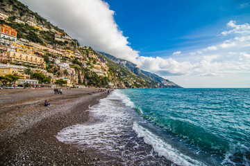 Panoramic view of the beach with colorful buildings of Positano, Italy.