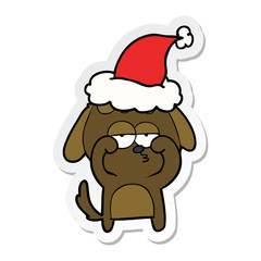 sticker cartoon of a tired dog wearing santa hat