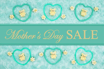 Mother's Day Sale message with teal frame hearts, teddy bears and rose buds on a teal plush fabric...