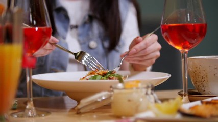 A woman in a restaurant eating pasta fettuccine