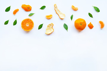 Fresh orange citrus fruit with green leaves on white.