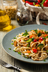 stir-fry pasta with chicken, broccoli and carrots.