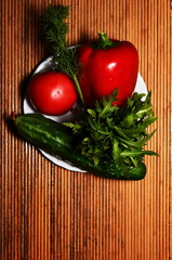 fresh vegetables on dark background tomato, sweet pepper, greens, cucumber copy space