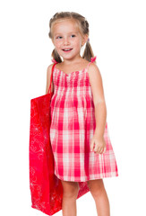 Cute litle girl with red shopping bag isolated on a white background