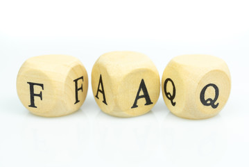The letters FAQ in wooden cubes on white background