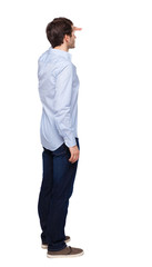 Back view of man in dark jeans. Standing young guy.