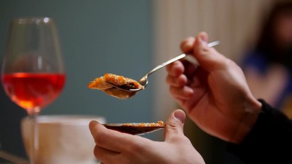 Cooked mussels. A man eating the mussel with a fork