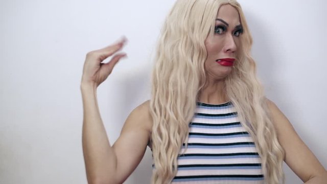 Close-up shot of a beautiful transgender woman doing a too much talking hand gesture