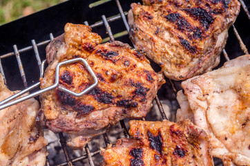 Chicken steak on the grill. Cooking chicken on the barbeque with charcoal in garden.
