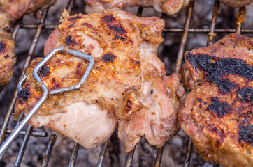 Chicken steak on the grill. Cooking chicken on the barbeque with charcoal in garden.