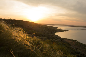 beautiful summer landscape with lake, hills and sunset	