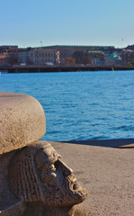 stone carved bench with view of citybay in daylight