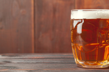 Glass beer on wood background