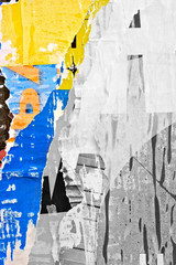 Fototapeta premium Old grunge ripped torn vintage collage street posters creased crumpled paper surface placard texture background backdrop / Selective color