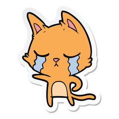 sticker of a crying cartoon cat pointing