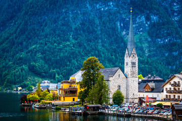Beautiful view of protestant church clock tower on the scenery of lake and mountain in Hallstatt , Austria