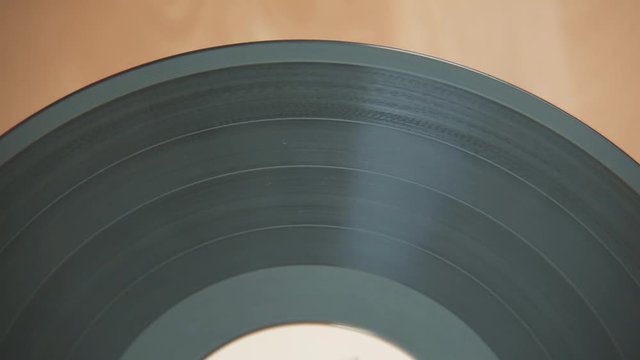 Old vinyl records are spinning very slowly, removed large parts of the plates