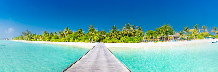 Naklejka na ściany i meble Maldives paradise scenery. Tropical landscape of palm trees and long jetty with white sandy beach. Exotic tourism destination banner