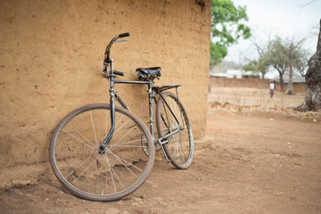 Fototapeta na wymiar An old bicycle standing against a wall in Malawi.