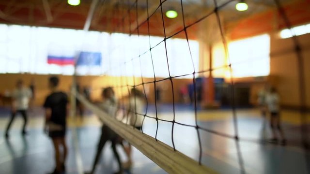 High School Volleyball Match In Gymnasium