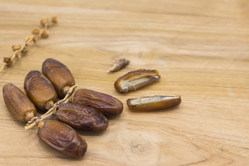 Close up fruits of date palm on wood background,fresh date-palm and dry date-palm on rustic wooden 