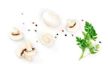 Champignon mushrooms, whole and sliced, shot from the top on a white background with pepper and parsley leaves, a flat lay composition with a place for text