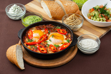 shakshuka in the pan and food on a table