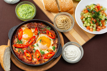 shakshuka in the pan and food on a table