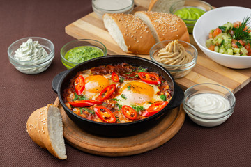 shakshuka in the pan and food on a table