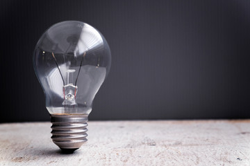 Business success and innovation concept, closeup shot image of light bulb over gray background