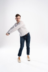 Naklejka premium Funny man in casual is having some fun. He is posing and dancing. Isolated on white background.