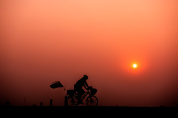 Obraz premium ride bicycle with sunset background.