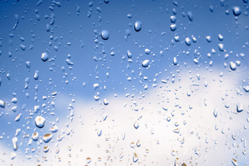 Beautiful raindrops on the window glass. Spring summer weather with warm rain. Stock photo