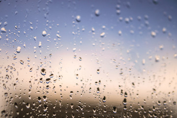 Beautiful raindrops on the window glass. Spring summer weather with warm rain. Stock photo
