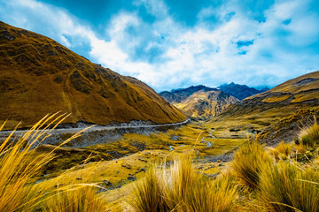 Sunshine view of spacious green valley among rocky high mountains