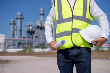  Engineer or Technician man in working shirt working with tablet for work security control at power plant energy industry  