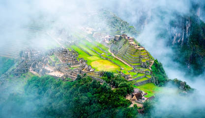 Aerial view of mountainious forested Machupicchu covered with clouds