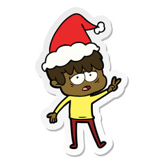 sticker cartoon of a exhausted boy wearing santa hat